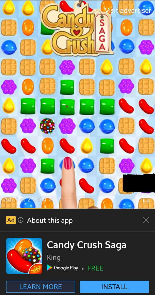 A screenshot of a playable ad for the popular game Candy Crush Saga. The ad features an interactive preview of the game's interface, showing colorful candies arranged in a grid. A finger is shown tapping a candy, demonstrating the gameplay. At the bottom, there is an install prompt with the options to "Learn More" or "Install" the game from the Google Play Store, highlighting how interactive ads engage users and encourage app downloads.