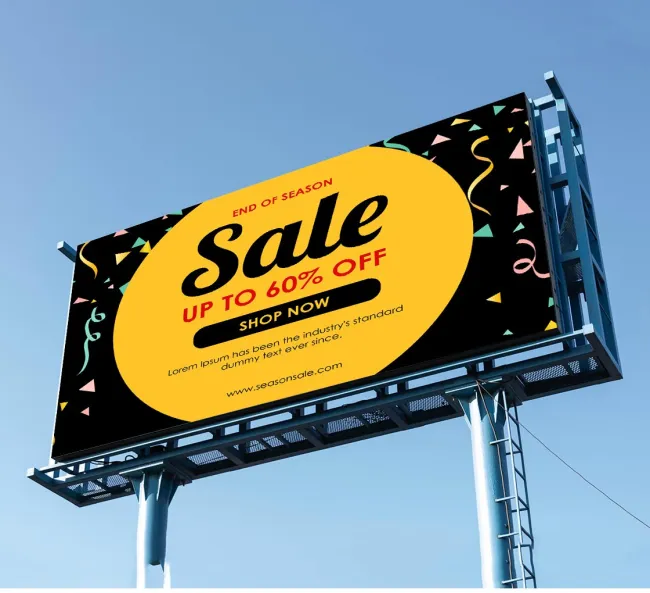 A large outdoor billboard displaying an advertisement for an "End of Season Sale" with up to 60% off. The ad features a bright yellow circle with the word "Sale" in bold black letters and additional text in red and black. The background of the billboard is black with colorful confetti graphics, creating a festive and eye-catching design. The billboard is mounted on a sturdy metal frame against a clear blue sky.