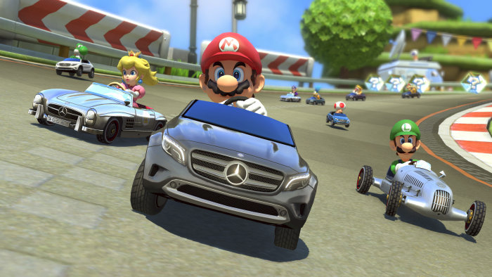 Mario Kart 8 gameplay featuring Mario, Luigi, and Princess Peach racing in Mercedes-Benz cars on a vibrant and dynamic race track.